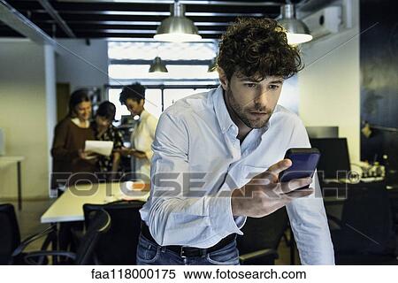 Businessman using smartphone View Large Photo Image Stock Photography - Businessman using smartphone. Fotosearch
