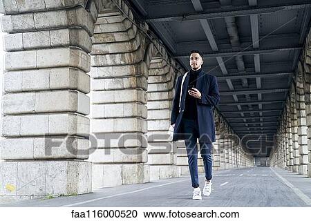 Businessman walking outdoors View Large Photo Image Stock Image - Businessman walking outdoors. Fotosearch