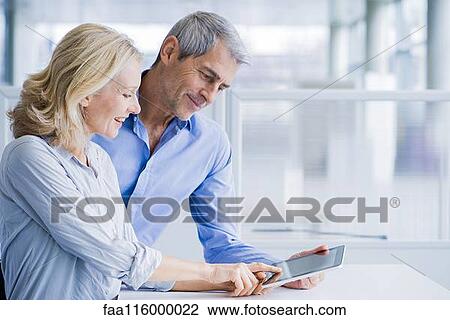 Businesspeople using digital tablet View Large Photo Image Stock Image - Businesspeople using digital tablet. Fotosearch