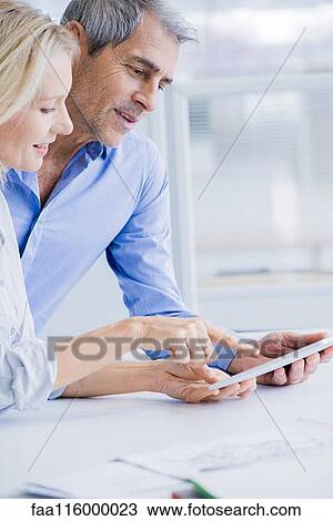 Businesspeople using digital tablet View Large Photo Image Stock Image - Businesspeople using digital tablet. Fotosearch