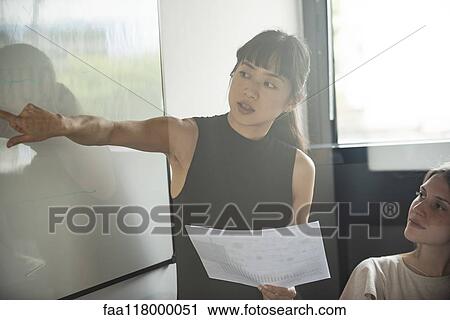 Businesswoman giving presentation in office View Large Photo Image Stock Image - Businesswoman giving presentation in office. Fotosearch