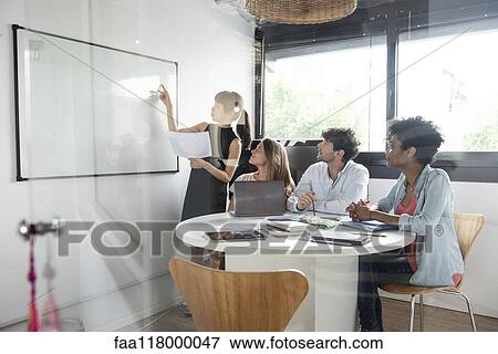 Businesswoman giving presentation in office View Large Photo Image Stock Photo - Businesswoman giving presentation in office. Fotosearch