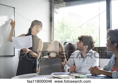 Businesswoman giving presentation in office View Large Photo Image Stock Photograph - Businesswoman giving presentation in office. Fotosearch