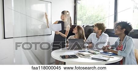 Businesswoman giving presentation in office View Large Photo Image Stock Photography - Businesswoman giving presentation in office. Fotosearch