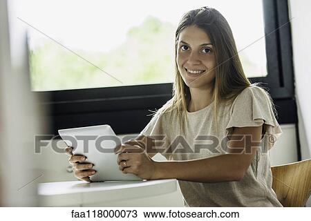 Stock Image - Businesswoman holding digital tablet. Fotosearch