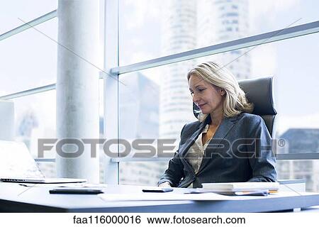 Businesswoman in office View Large Photo Image Stock Photograph - Businesswoman in office. Fotosearch