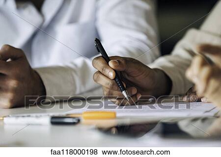 Stock Photo - Businesswoman signing document. Fotosearch