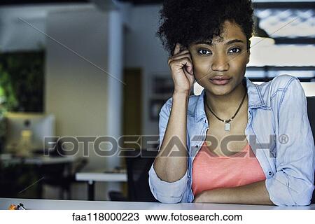 Businesswoman sitting in office View Large Photo Image Stock Image - Businesswoman sitting in office. Fotosearch
