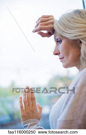 Businesswoman standing near window View Large Photo Image Stock Image - Businesswoman standing near window. Fotosearch