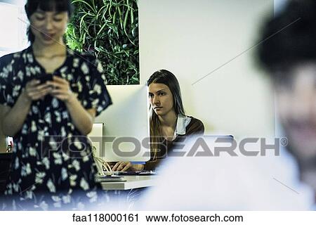 Stock Image - Businesswoman using computer. Fotosearch