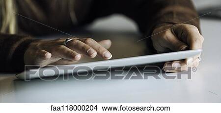 Picture - Businesswoman using digital tablet. Fotosearch