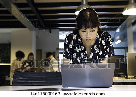 Stock Image - Businesswoman using laptop. Fotosearch