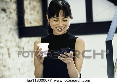 Businesswoman using smartphone View Large Photo Image Stock Photo - Businesswoman using smartphone. Fotosearch