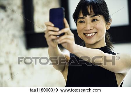 Businesswoman using smartphone View Large Photo Image Stock Photo - Businesswoman using smartphone. Fotosearch