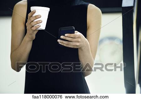 Stock Photograph - Businesswoman using smartphone. Fotosearch