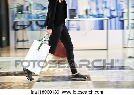 Businesswoman walking in hotel lobby View Large Photo Image Stock Image - Businesswoman walking in hotel lobby. Fotosearch
