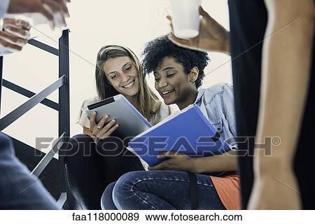 Businesswomen using digital tablet in office View Large Photo Image Stock Photo - Businesswomen using digital tablet in office. Fotosearch