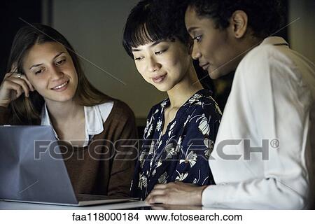 Picture - Businesswomen using laptop. Fotosearch