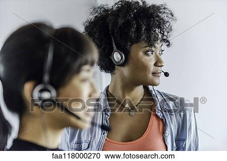 Businesswomen wearing headset View Large Photo Image Stock Image - Businesswomen wearing headset. Fotosearch