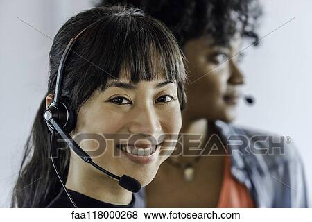Businesswomen wearing headset View Large Photo Image Stock Photo - Businesswomen wearing headset. Fotosearch