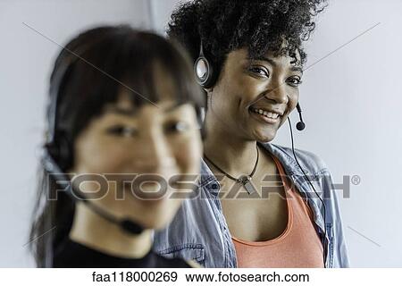 Businesswomen wearing headset View Large Photo Image Stock Photo - Businesswomen wearing headset. Fotosearch