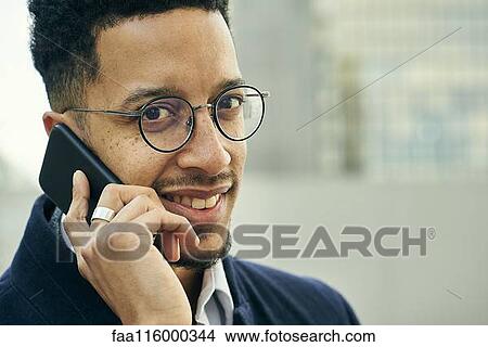 Close-up of businessman talking on smartphone View Large Photo Image Picture - Close-up of businessman talking on smartphone. Fotosearch
