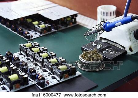 Close-up of circuit board on desk View Large Photo Image Stock Photo - Close-up of circuit board on desk. Fotosearch