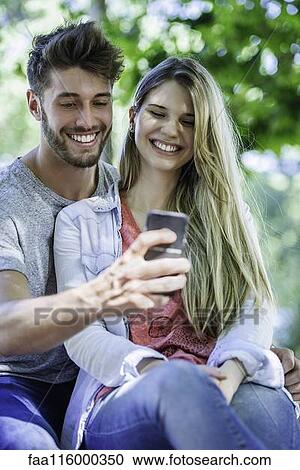 Close-up of couple taking selfie with smartphone View Large Photo Image Stock Image - Close-up of couple taking selfie with smartphone. Fotosearch