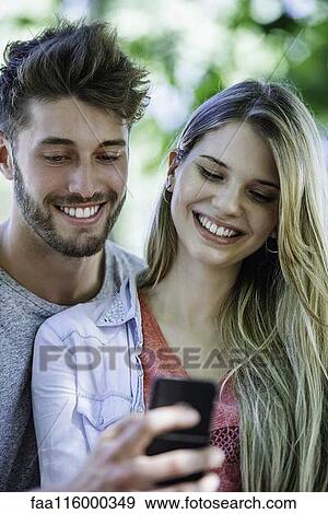 Close-up of couple taking selfie with smartphone View Large Photo Image Stock Photo - Close-up of couple taking selfie with smartphone. Fotosearch