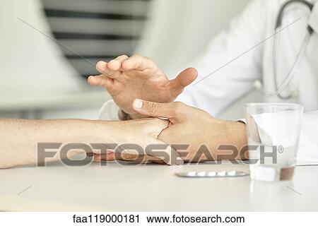 Close-up of doctor holding patient's hand View Large Photo Image Stock Image - Close-up of doctor holding patient's hand. Fotosearch