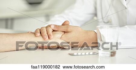 Close-up of doctor holding patient's hand View Large Photo Image Stock Image - Close-up of doctor holding patient's hand. Fotosearch