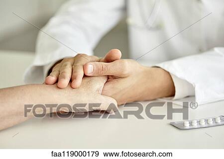 Close-up of doctor holding patient's hand View Large Photo Image Stock Photo - Close-up of doctor holding patient's hand. Fotosearch
