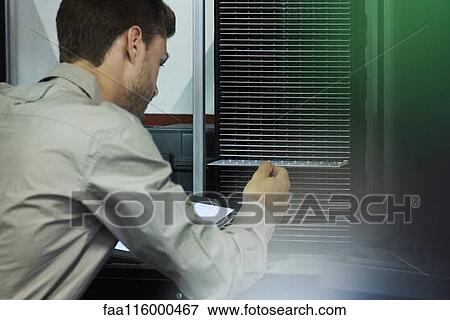 Close-up of engineer inserting chip into machine View Large Photo Image Stock Photo - Close-up of engineer inserting chip into machine. Fotosearch