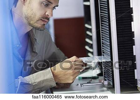 Close-up of engineer inserting chip into machine View Large Photo Image Stock Photography - Close-up of engineer inserting chip into machine. Fotosearch