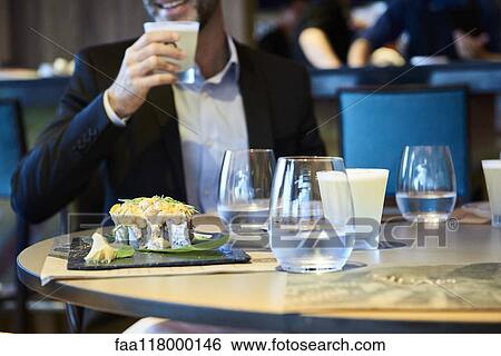Close-up of food and drinks served on table View Large Photo Image Stock Photograph - Close-up of food and drinks served on table. Fotosearch