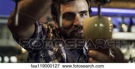 Close-up of man drawing beer from tap View Large Photo Image Stock Photo - Close-up of man drawing beer from tap. Fotosearch