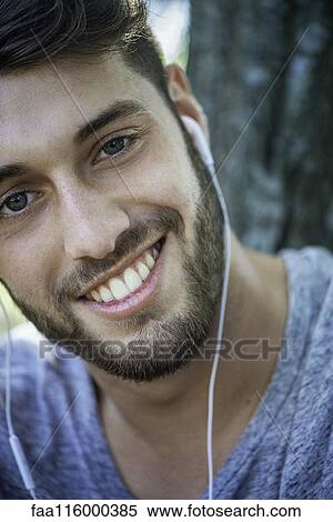 Close-up of smiling young man View Large Photo Image Stock Photography - Close-up of smiling young man. Fotosearch