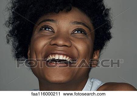 Close-up of smiling young woman View Large Photo Image Stock Image - Close-up of smiling young woman. Fotosearch