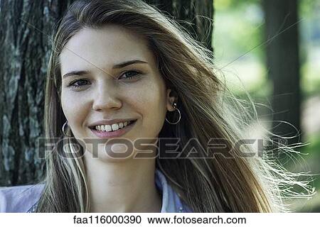 Close-up of smiling young woman View Large Photo Image Stock Image - Close-up of smiling young woman. Fotosearch