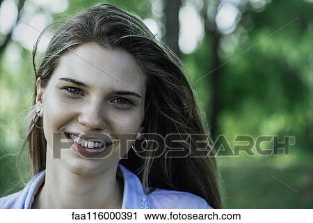 Stock Image - Close-up of smiling young woman. Fotosearch