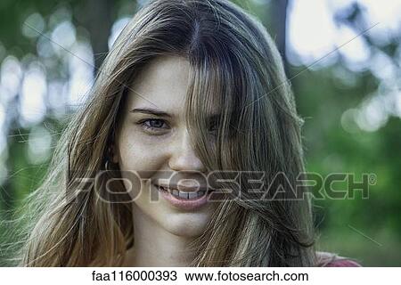 Close-up of smiling young woman View Large Photo Image Stock Image - Close-up of smiling young woman. Fotosearch