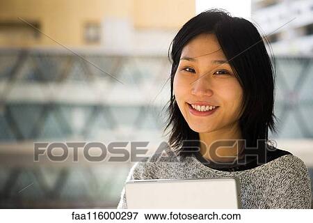 Stock Photo - Close-up of smiling young woman. Fotosearch