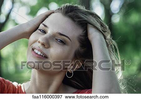 Close-up of smiling young woman View Large Photo Image Stock Photo - Close-up of smiling young woman. Fotosearch