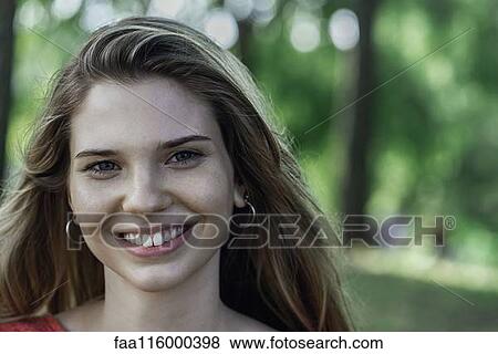 Close-up of smiling young woman View Large Photo Image Stock Photo - Close-up of smiling young woman. Fotosearch