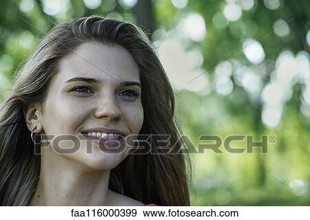 Close-up of smiling young woman View Large Photo Image Stock Photo - Close-up of smiling young woman. Fotosearch
