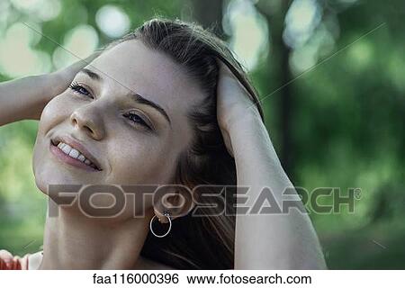 Stock Photograph - Close-up of smiling young woman. Fotosearch