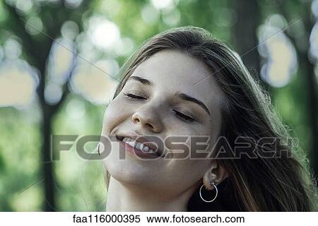 Close-up of smiling young woman View Large Photo Image Stock Photography - Close-up of smiling young woman. Fotosearch