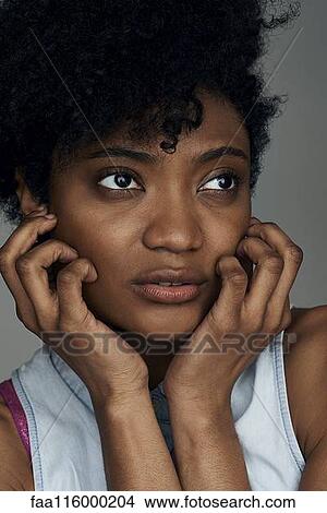 Close-up of thoughtful young woman View Large Photo Image Picture - Close-up of thoughtful young woman. Fotosearch