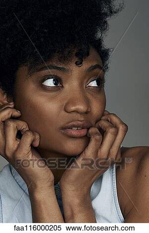 Close-up of thoughtful young woman View Large Photo Image Stock Photography - Close-up of thoughtful young woman. Fotosearch