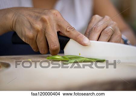 Close-up of woman cutting green beans View Large Photo Image Picture - Close-up of woman cutting green beans. Fotosearch